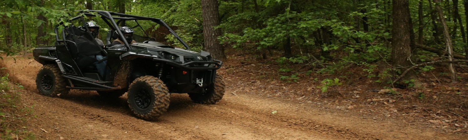 Two individuals offroading in a Bobcat CT2025 UTV.